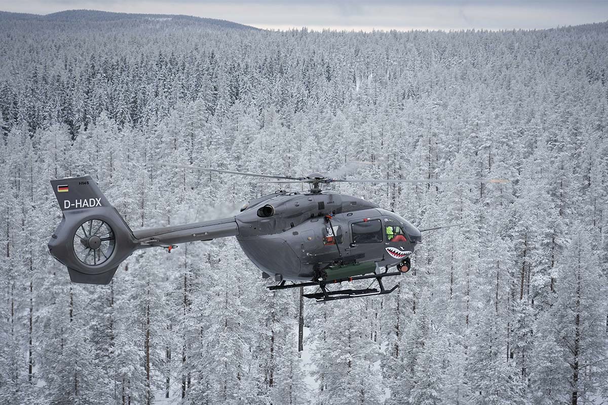 H145M helicopter flying over Älvdalen Firing Range in wintertime