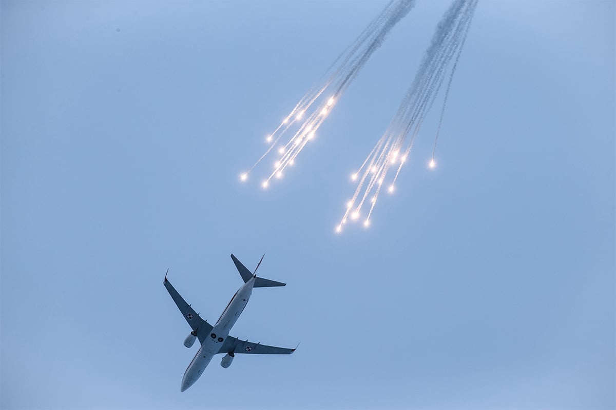 Aircraft in the air, ejecting flares