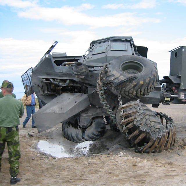 A demolished vehicle tipping over after test